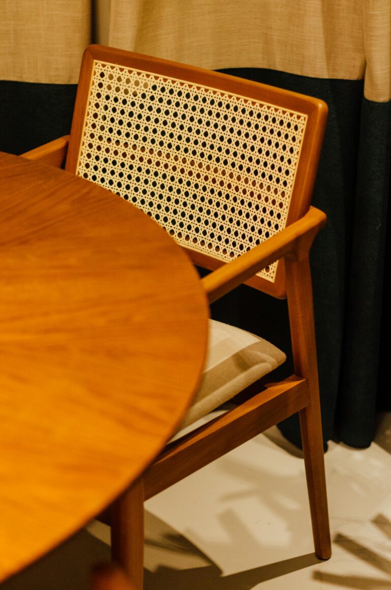 Close-up of a mid-century modern wooden chair and round table.